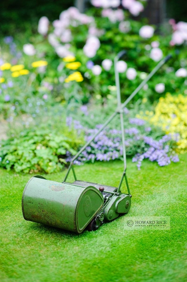 Vintage hand pushed cylinder mower with grass box made by JP Lawnmowers, June