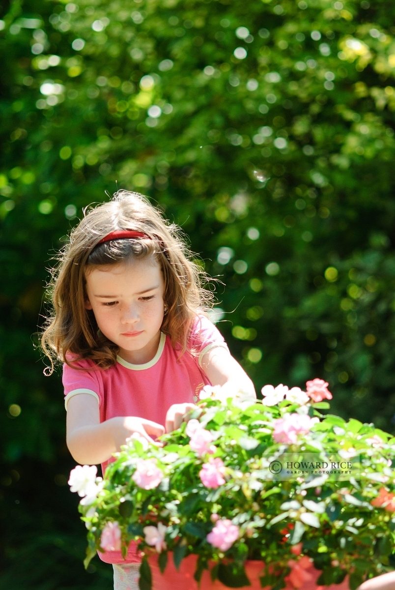 girl tending bedding plants